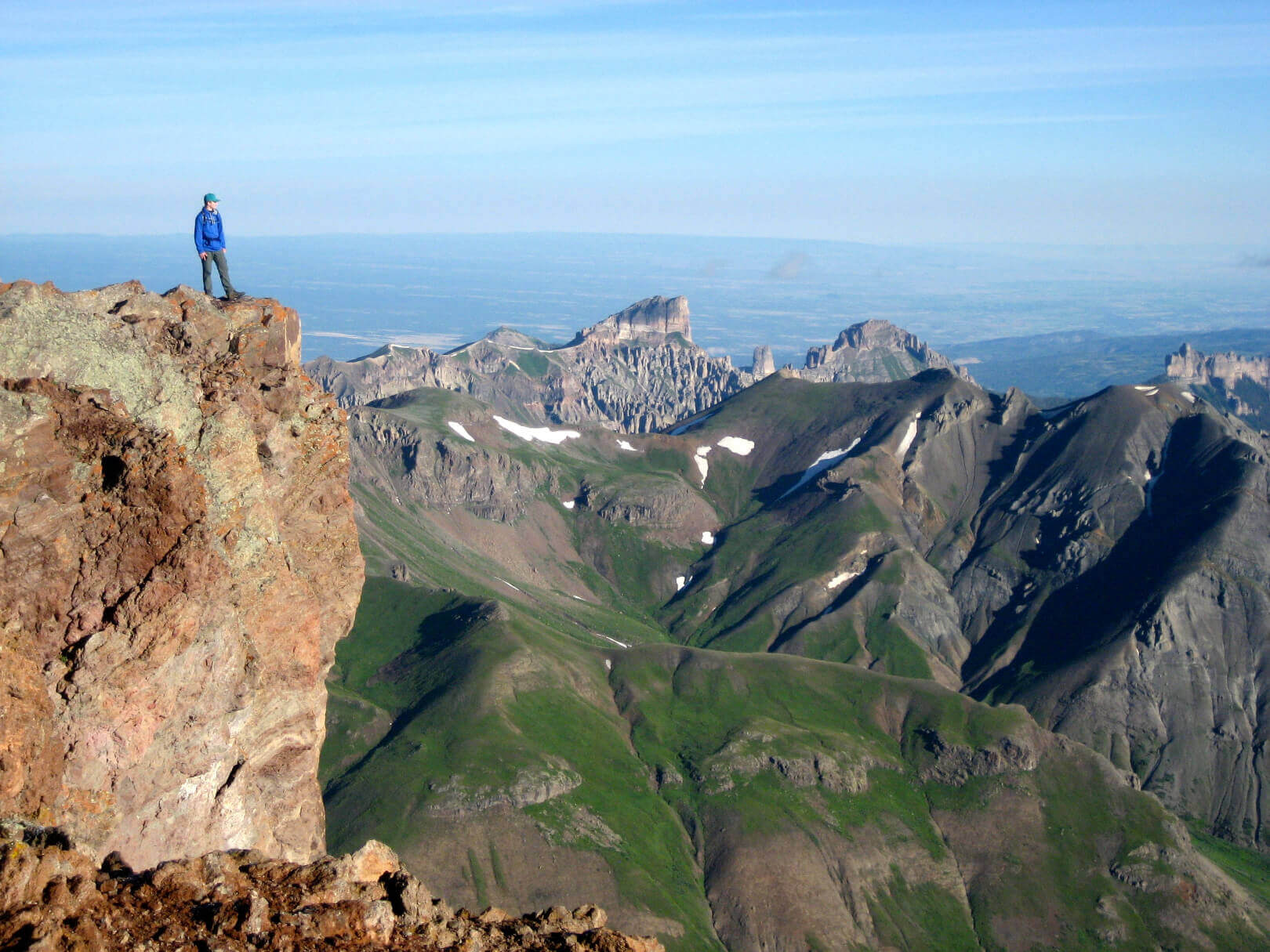 A man standing on the edge of a mountain